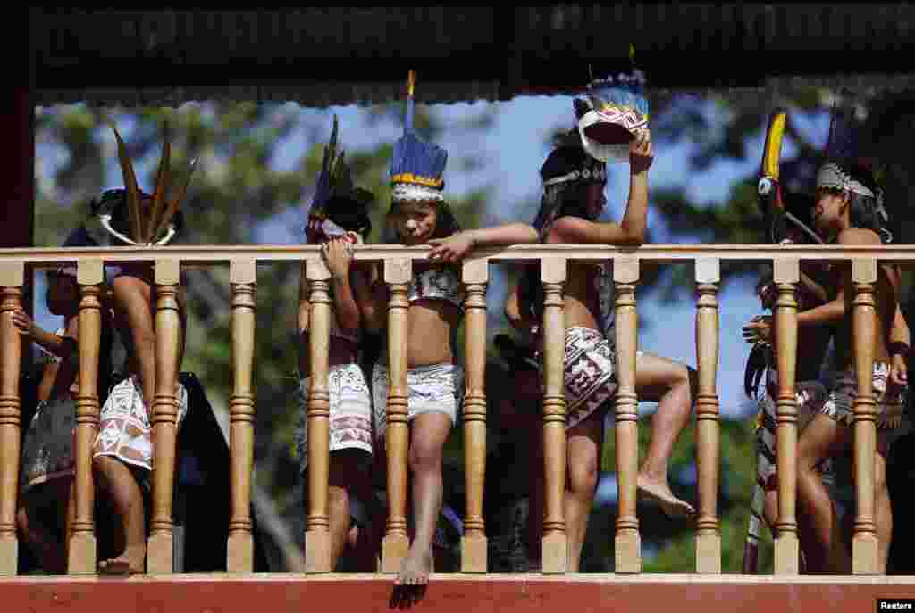 Indigenous Bora children wait before a welcoming ceremony for a presidential meeting in Iquitos, Peru, Sept. 30, 2014. 