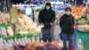 Masked customers are seen shopping at a supermarket in Nanjing, east China's Jiangsu province, on Jan. 17, 2025. 