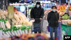 Masked customers are seen shopping at a supermarket in Nanjing, east China's Jiangsu province, on Jan. 17, 2025. 