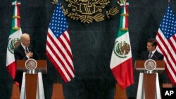 U.S. Vice President Joe Biden puts his hand to his chest as he tells Mexican President Enrique Pena Nieto that U.S. campaign rhetoric about Mexico and immigrants does not represent the view of most Americans, in Mexico City, Feb. 25, 2016.