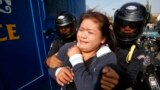 A protester is detained during an attempt to deliver a petition, near the French embassy, in Phnom Penh January 21, 2014. Eleven protesters, including Cambodian activists Yorm Bopha and Tep Vanny, were detained while trying to deliver petitions to foreign embassies in Phnom Penh, calling for help in securing the release of 23 men who were jailed for joining a strike earlier this month over garment factory wages, according to local rights groups.