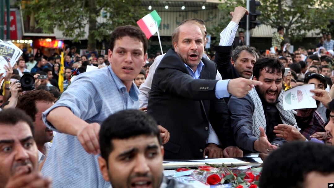 FILE - Iranian presidential candidate, Mohammad Bagher Qalibaf, who is also Tehran's mayor, points, during a campaign rally in Tehran, Iran, June 12, 2013.