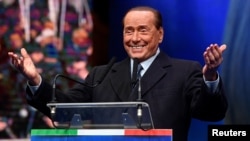 FILE - Former Italian Prime Minister and leader of the Forza Italia (Go Italy!) party Silvio Berlusconi gestures during a rally ahead of a regional election in Emilia-Romagna, in Ravenna, Jan. 24, 2020.