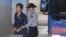 Former South Korean President Park Geun-hye, left, arrives for her trial at the Seoul Central District Court in Seoul, South Korea, Oct. 16, 2017. 