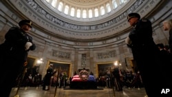 Guests pay their respects as the flag-draped casket of former President Jimmy Carter lies in state at the U.S. Capitol, in Washington, Jan. 8, 2025. Carter died Dec. 29 at the age of 100. 