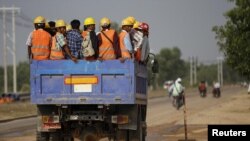 Workers are transported via truck to the site of the Thilawa Special Economic Zone (SEZ) project at Thilawa May 8, 2015. REUTERS/Soe Zeya Tun/File Photo - S1BEUBGAUIAA