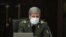 A handout picture provided by the Iranian presidency on March 11, 2020 shows Iranian Defense Minister Brigadier General Amir Hatami wearing a protective mask and gloves during a cabinet meeting in the capital Tehran.