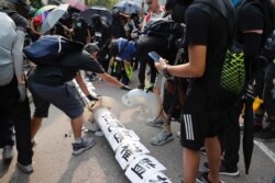 Demonstrators put papers on a fallen smart lamppost during a protest in Hong Kong, Aug. 24, 2019.