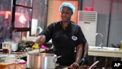 Chef Hilda Baci cooks to establish a new Guinness world record for the "longest cooking marathon", the 97-hour cook-a-thon, in Lagos, Nigeria, Thursday, May 11, 2023. (AP Photo/Sunday Alamba)