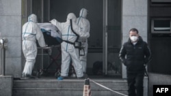 Medical staff transport a patient to Jinyintan Hospital, where patients infected by a mysterious SARS-like virus are being treated, in Wuhan, in China's central Hubei province, Jan. 18, 2020.