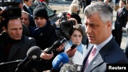 Kosovo's Prime Minister Hashim Thaci (R) talks to the media as he arrives for a meeting with Serbian Prime Minister Ivica Dacic (unseen) and European Union foreign policy chief Catherine Ashton (unseen) in Brussels, April 2, 2013. 