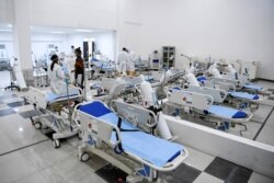 Staff inspect medical equipments at an emergency hospital set up amid the new coronavirus outbreak in Jakarta, Indonesia, March 23, 2020.