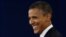 Obama smiles at moderator Jim Lehrer