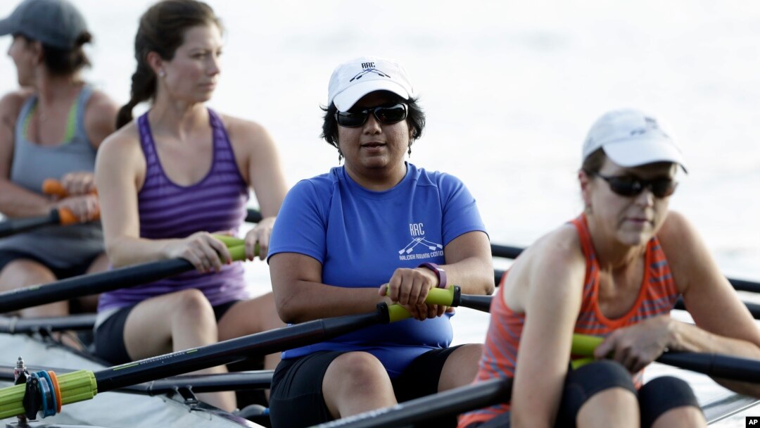 FILE - Manasi Gopala, second from right, rows during her sculling class at Lake Wheeler in Raleigh, N.C., Aug. 30, 2016. When Gopala immigrated to America, she finally got the chance to row crew. 