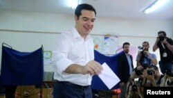 Greek Prime Minister Alexis Tsipras votes at a polling station in Athens, July 5, 2015. 