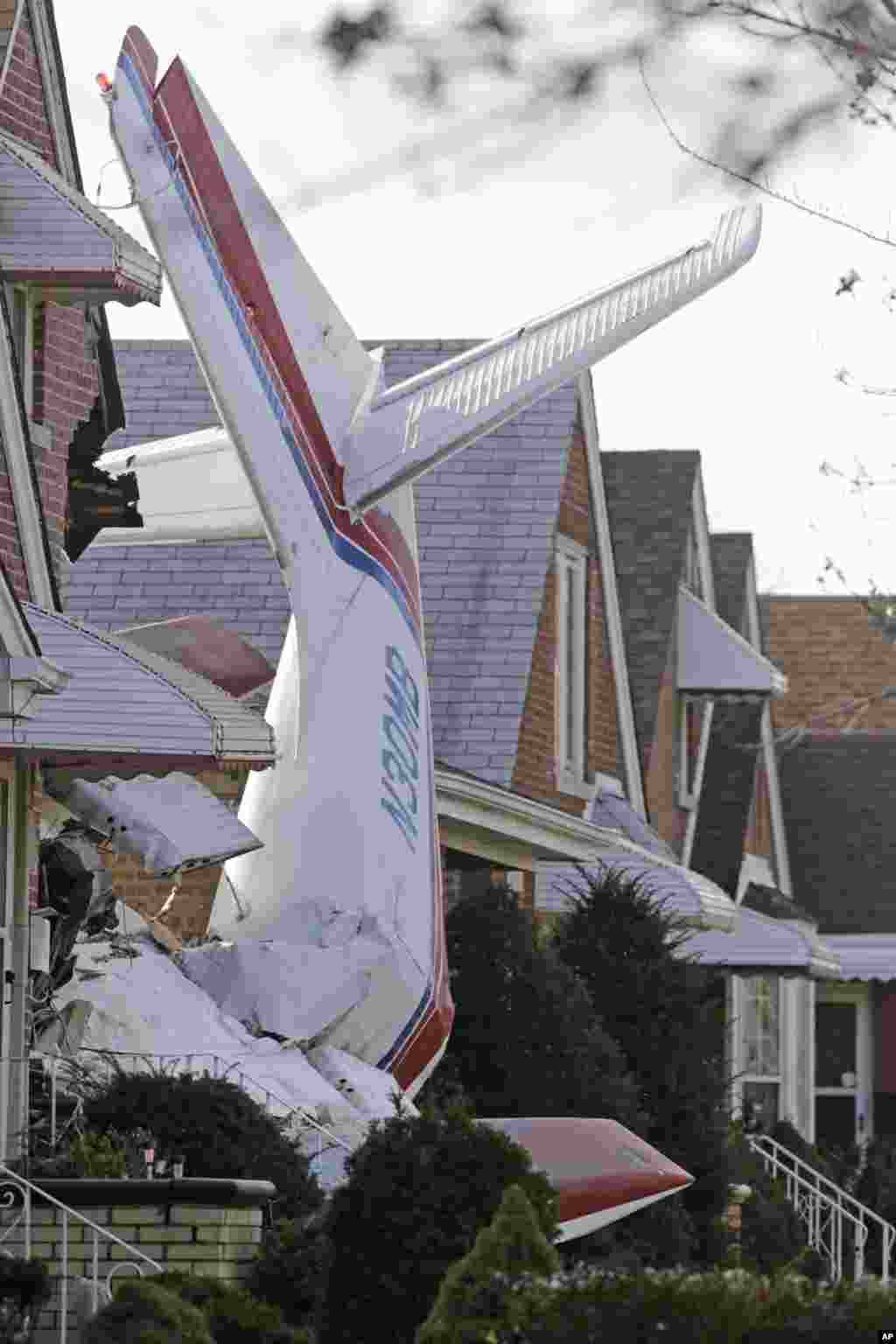 The wreckage of a small twin-engine cargo plane lies where the aircraft crashed into a home on Chicago&#39;s southwest side early. The Aero Commander 500 that had taken off from Midway International Airport when it slammed into the front of the home and plunged into the basement.