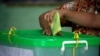 FILE - A voter casts her ballot in a by-election in Yangon, Myanmar, Nov. 3, 2018.