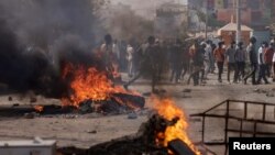 FILE — People in Senegal protest the postponement of the elections that were scheduled for February 25, in Dakar, Senegal on February 9, 2024.