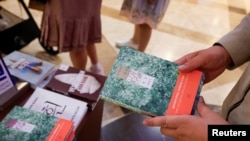 A person holds the book 'Human Acts' by Han Kang, who won the 2024 Nobel Prize in Literature, in a bookstore in Seoul, South Korea Oct. 10, 2024.