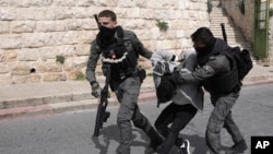 FILE —Israeli Border Police detain a Palestinian man ahead of Friday prayers at the Al-Aqsa Mosque compound in the Old City of Jerusalem, March 1, 2024.