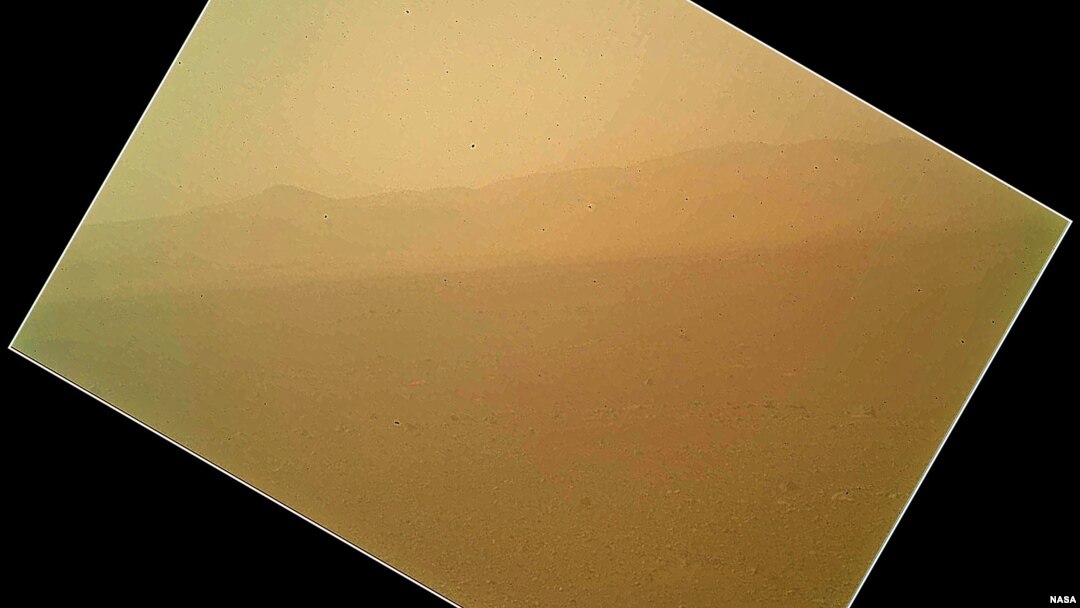 The image shows the north wall and rim of Gale Crater in the distance. The image shown here has been rotated to correct for that tilt, so that the sky is up and the ground is down. (photo: NASA)