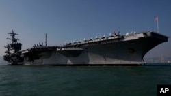 The aircraft carrier USS Carl Vinson is anchored in Hong Kong water, Dec. 27, 2011. The carrier currently is headed towards the Korean Peninsula as a “prudent measure.”