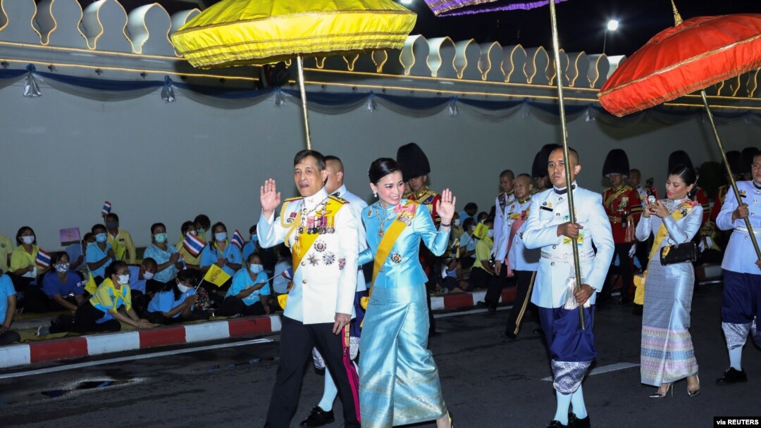 Thailand's King Maha Vajiralongkorn and Queen Suthida wave after a ceremony to celebrate the birthday of Queen Sirikit, the Queen Mother, in Bangkok, Thailand, Aug. 12, 2020. Protests have erupted in recent days denouncing the monarchy.