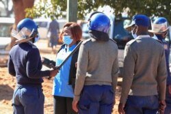 FILE - Police arrest a health worker during a protest against economic hardship and poor working conditions during the coronavirus disease (COVID-19) outbreak in Harare, Zimbabwe, July 6, 2020.