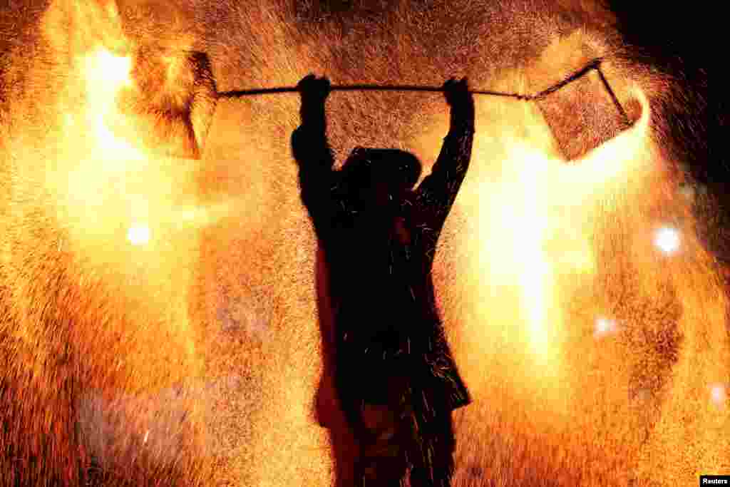 A folk artist takes part in a molten iron fireworks performance at Shanghai Happy Valley amusement park during the Lantern Festival, which marks the end of the Lunar New Year celebrations, in Shanghai, China.