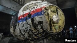 FILE - The reconstructed wreckage of the MH17 airplane is seen after the presentation of the final report into the crash of July 2014 of Malaysia Airlines flight MH17 over Ukraine, in Gilze Rijen, the Netherlands, Oct. 13, 2015. 