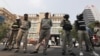 Cambodian police officers stand guard in front of the Phnom Penh Municipal Court, in Phnom Penh, Cambodia, Thursday, Jan. 16, 2020. (AP Photo)