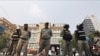 Cambodian police officers stand guard in front of the Phnom Penh Municipal Court during a hearing of Kem Sokha, the head of the dissolved Cambodia National Rescue Party, in Phnom Penh, Cambodia, Jan. 16, 2020.