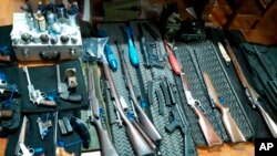 This photo provided by the Argentine Ministry of Security shows a cache of weapons seized by authorities at an undisclosed location in Argentina, June 26, 2019. 
