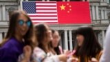 In this Thursday, Sept. 24, 2015, photo, China's flag is displayed next to the American flag on the side of the Old Executive Office Building on the White House complex in Washington.