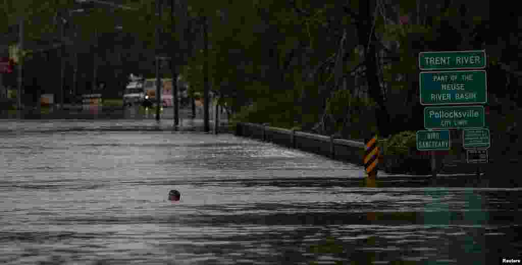A man swims in a flooded street after the passage of Hurricane Florence in New Bern, North Carolina, Sept. 16, 2018.
