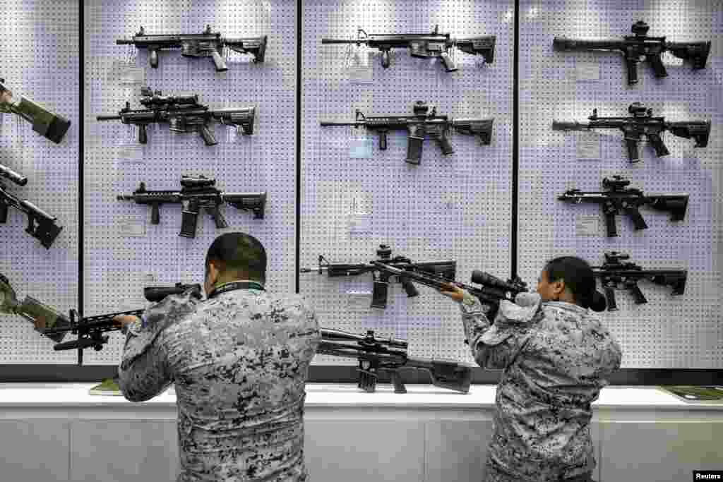 Philippine navy personnel check rifles on display during the Asian Defense and Security Exhibition at World Trade Center, Pasay City, Metro Manila, Philippines.