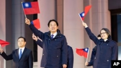 In this photo released by the Taiwan Presidential Office, Taiwan's President Lai Ching-te waves with the Taiwanese flag during a flag-raising ceremony in Taipei, Taiwan, Jan. 1, 2025. 