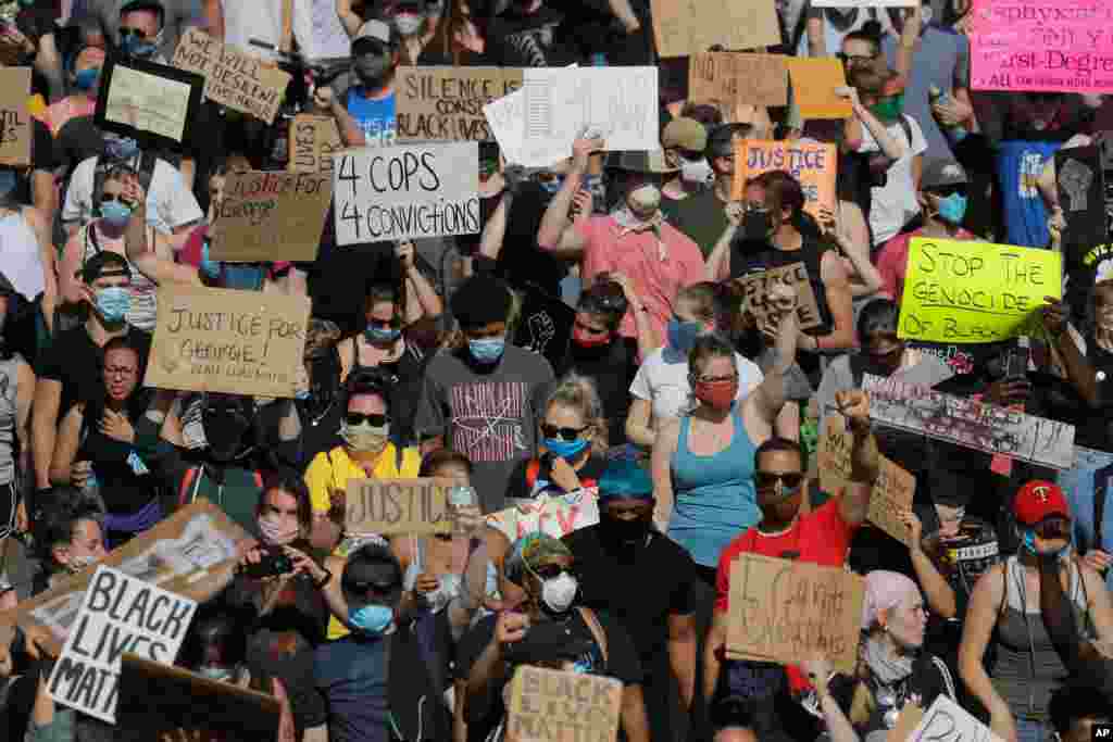 Demonstrators march on pavement, May 31, 2020, in Minneapolis. 