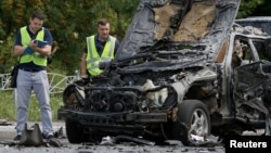 Investigators work at the scene of a car bomb explosion which killed Maxim Shapoval, a high-ranking official involved in military intelligence, in Kiev, Ukraine, June 27, 2017.