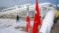 A worker walks past the pumping station on the border between Iran and Turkey during the inauguration ceremony for the Iran - Turkey gas pipeline, January 22, 2002. 