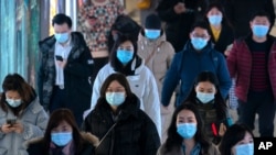 Vajeros que usan máscaras faciales para protegerse contra la propagación del coronavirus caminan por una estación de metro en Beijing, el miércoles 3 de marzo de 2021. [Foto: AP]