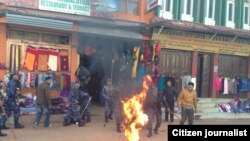 Nepalese police react to a Tibetan exile who set himself on fire in Kathmandu, February 13, 2013.