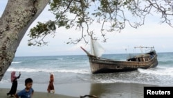 A wooden boat that carried Rohingya refugees rests at a beach in Ladong village, Indonesia, Dec. 25, 2022, in this photo taken by Antara Foto. 