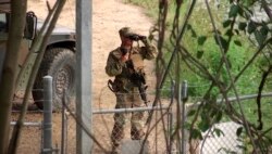 FILE - In this April 10, 2018, file frame from video, a National Guard troop watches over Rio Grande River on the border in Roma, Texas.