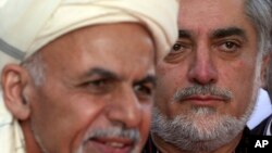 FILE - Afghanistan Chief Executive Abdullah Abdullah, right, listens as President Ashraf Ghani speaks at the presidential palace in Kabul, Oct. 4, 2014,