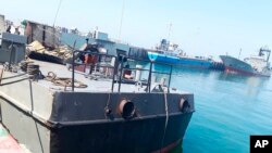 In this photo provided Monday, May 11, 2020, by the Iranian Army, the Konarak support vessel which was struck during a training exercise in the Gulf of Oman, is docked in an unidentified naval base in Iran.