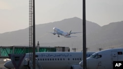 FILE - A plane takes off from Hamid Karzai International Airport in Kabul, Afghanistan, July 4, 2021.