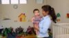 The factory offers day care so young mothers can continue their employment after a paid maternity leave. (S. Herman/VOA)