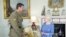 Britain's Queen Elizabeth II greets Corp. Ben Robert-Smith, from Australia, who was recently awarded the Victoria Cross, during an audience at Buckingham Palace in London, Nov.15, 2011. 