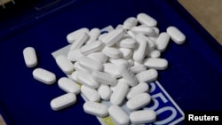 FILE - Tablets of the opioid-based hydrocodone are seen at a pharmacy in Portsmouth, Ohio, June 21, 2017. 